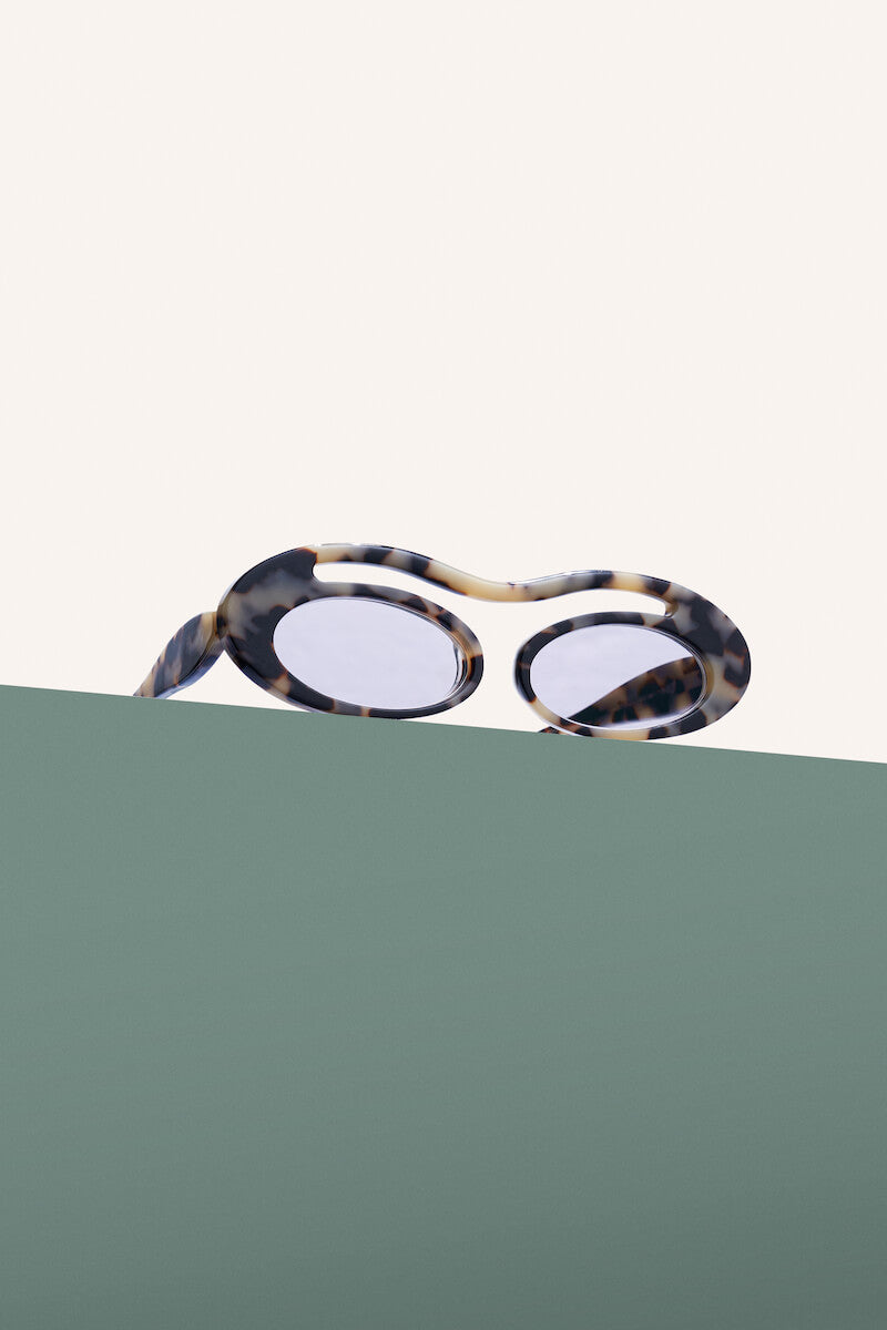 Maison Mata Moon river marbled acetate oval sunglasses, three-quarter view with polarized lenses