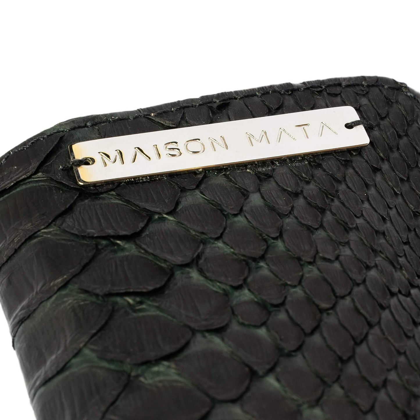 Engraved brass Maison Mata plate on the black snake softcase