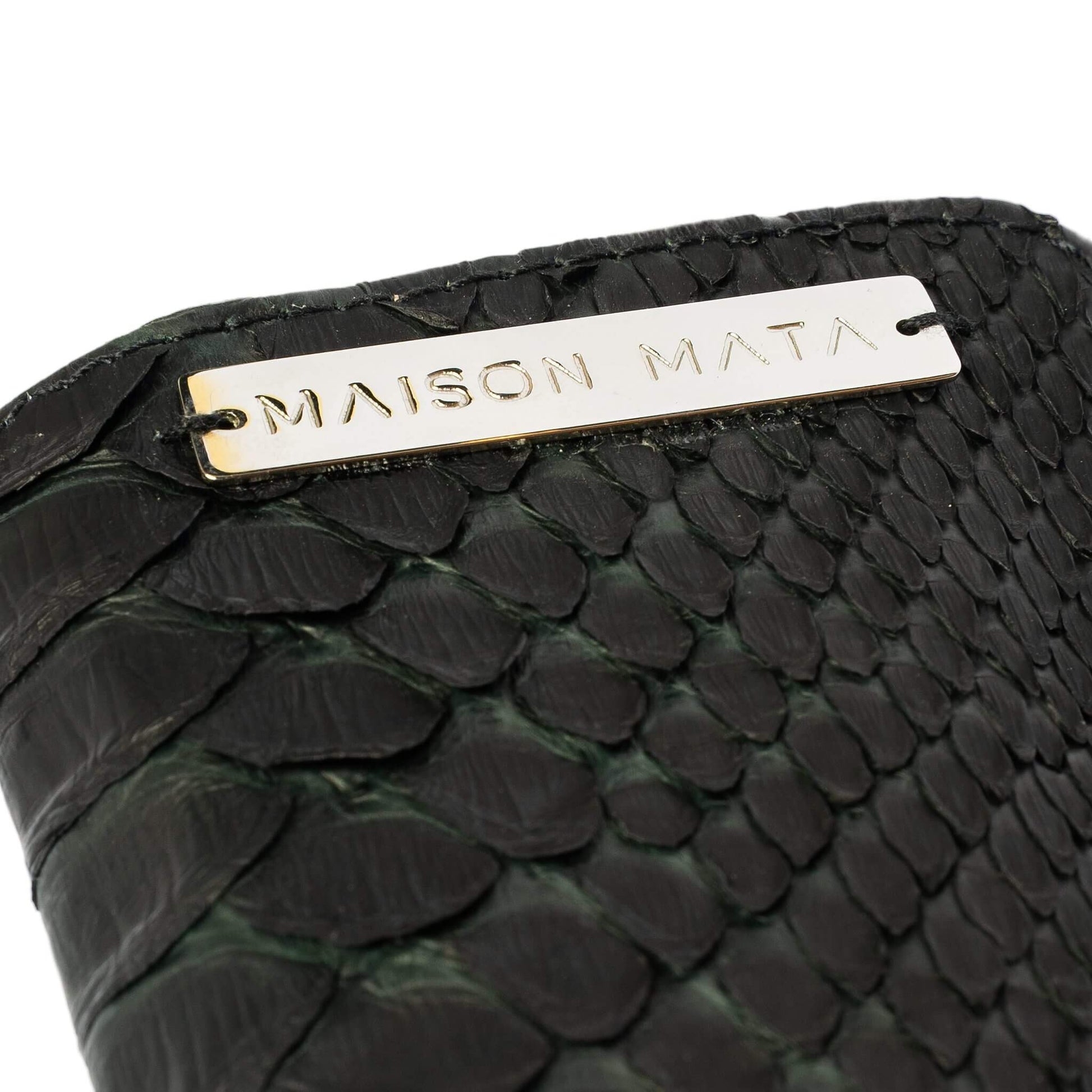 Engraved brass Maison Mata plate on the black snake softcase