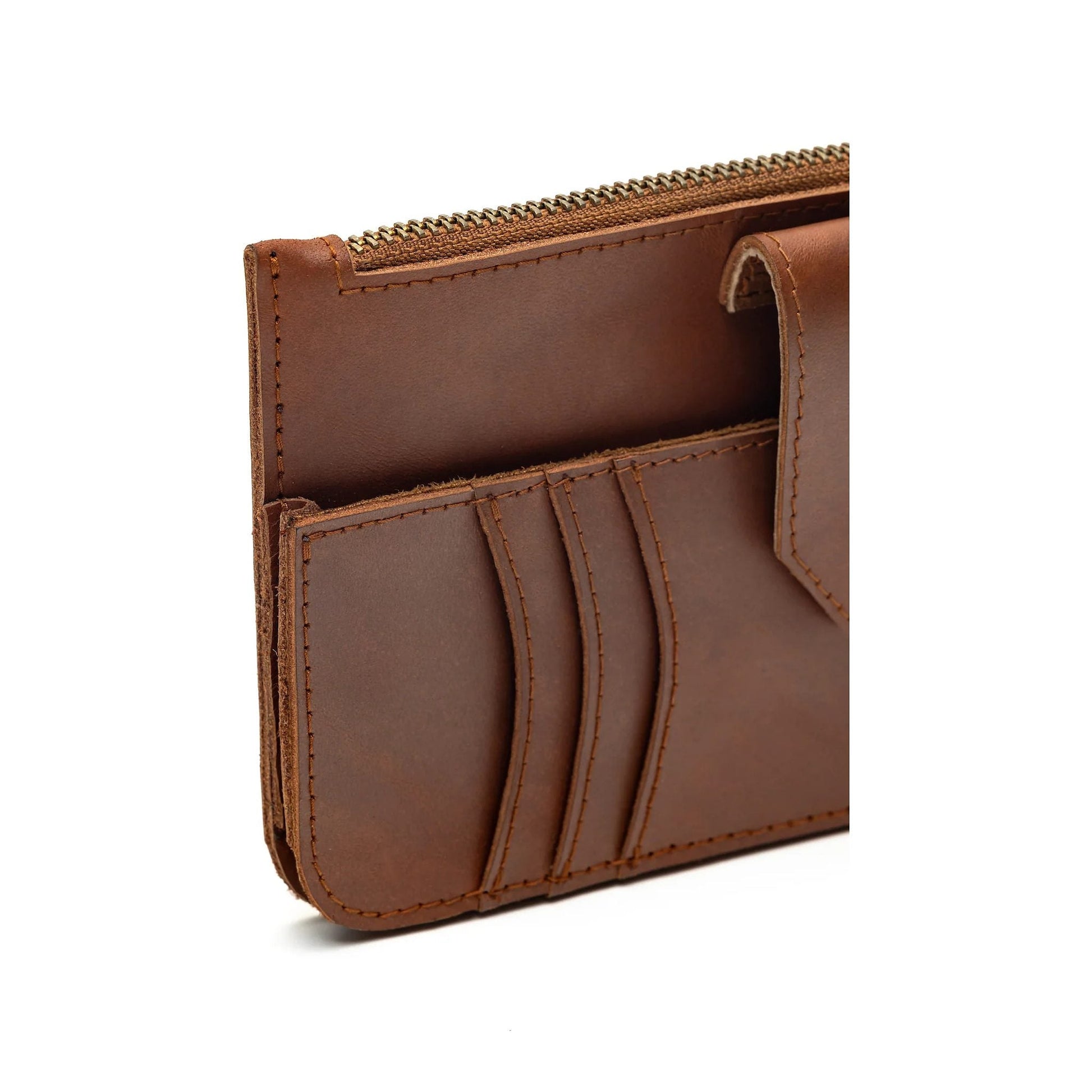 Three-quarter view of the Maison Mata brown leather wallet showing the zip and card pockets