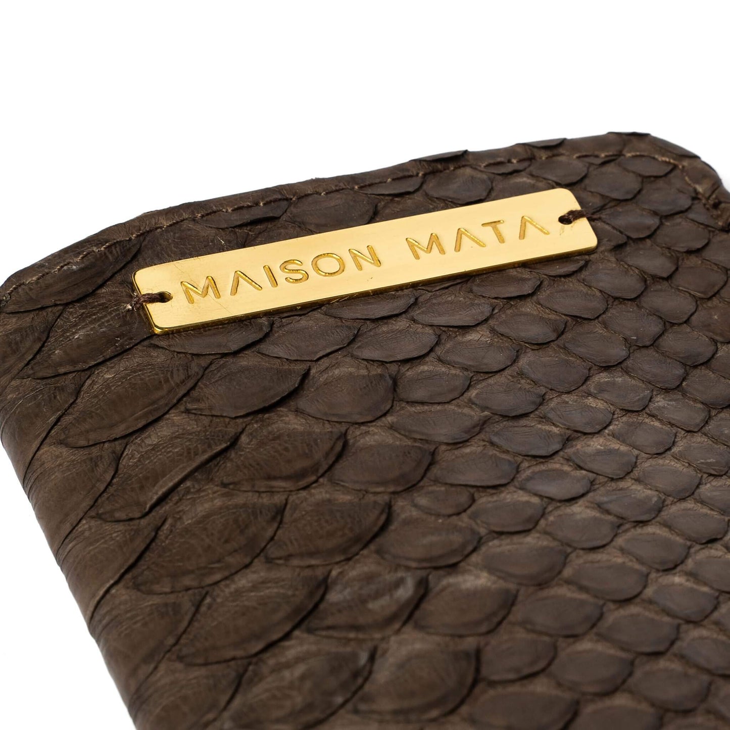 Engraved brass Maison Mata plate on the brown snake softcase