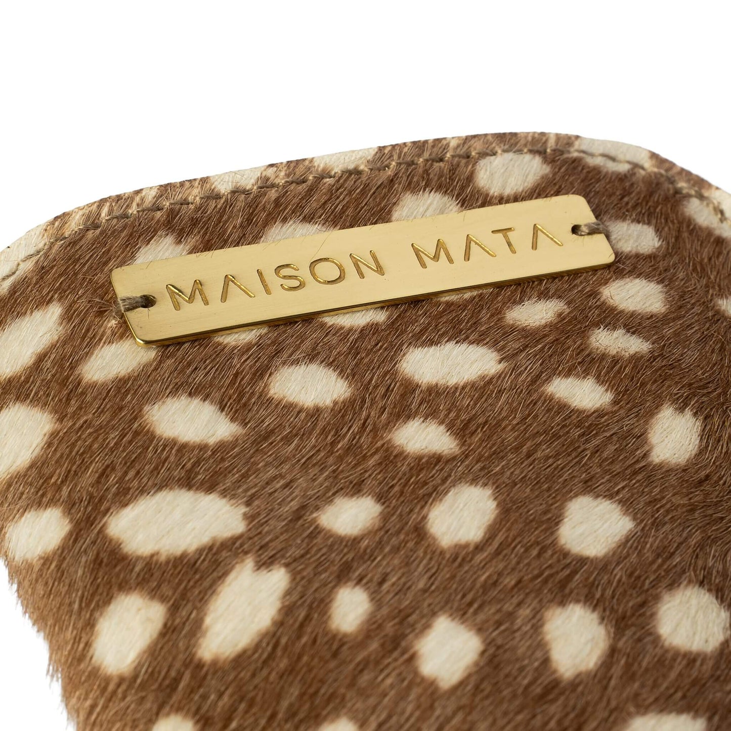 Engraved brass Maison Mata plate on the deer softcase