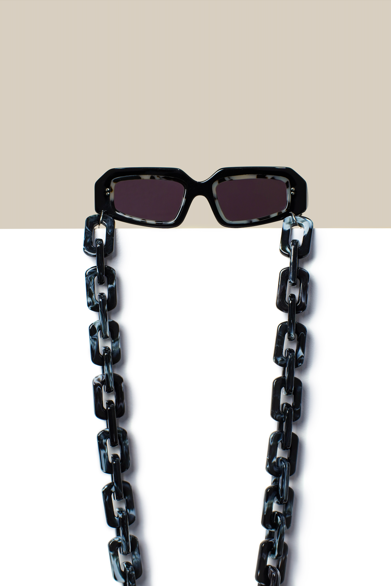 Rectangular black marbled acetate sunglasses adjusted by optometrists in Denpasar in Bali for bold minimalist everyday wear.