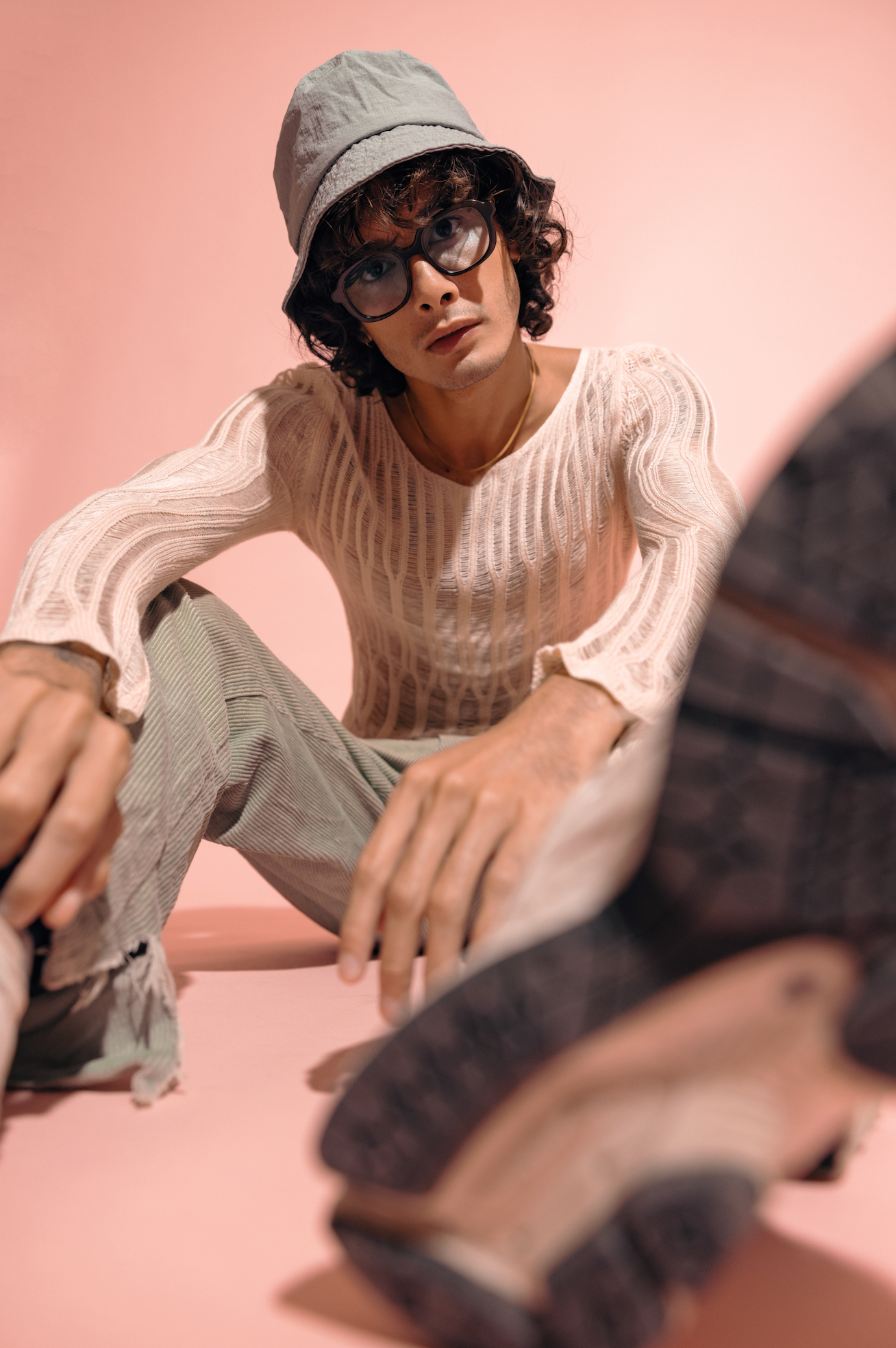 Man showcasing Maison Mata handmade polarized sunglasses inside a Bali villa space adjusted by experienced optometrists.