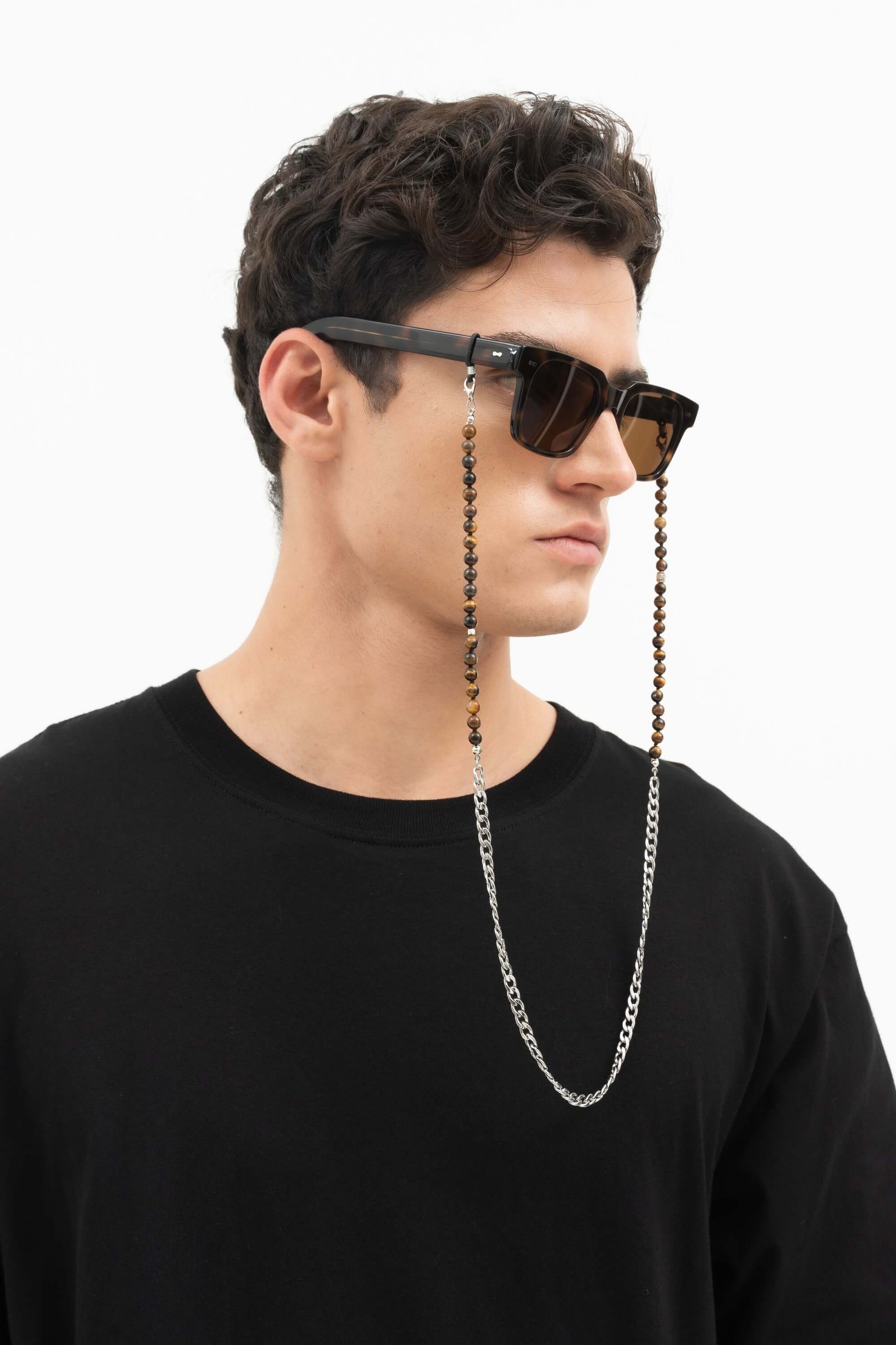 Side profile of man wearing Borneo Bliss Dark Forest sunglasses with an eyewear chain