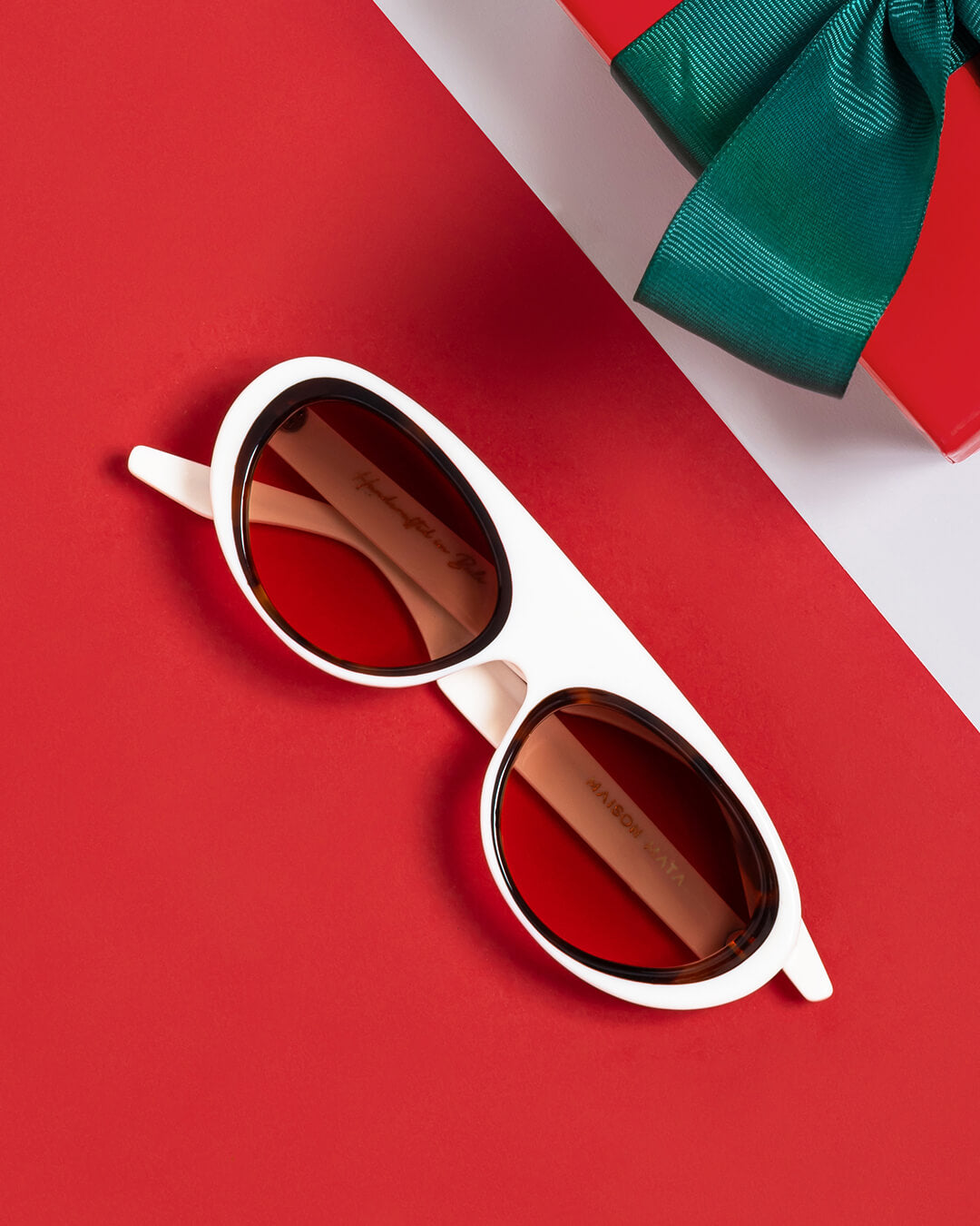 handcrafted white pilot sunglasses styled with gift on table – Maison Mata