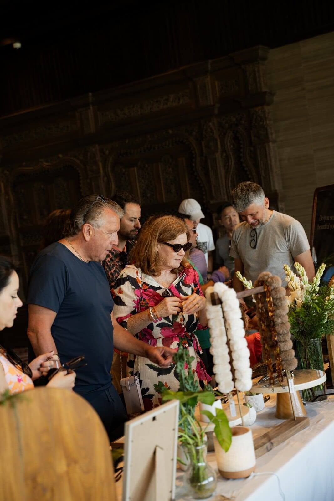 Maison Mata eyewear display with flowers and wooden trays in a hotel ballroom in Bali