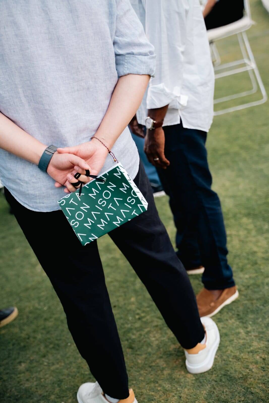 Guest leaving a Maison Mata gifting experience with a branded paper bag