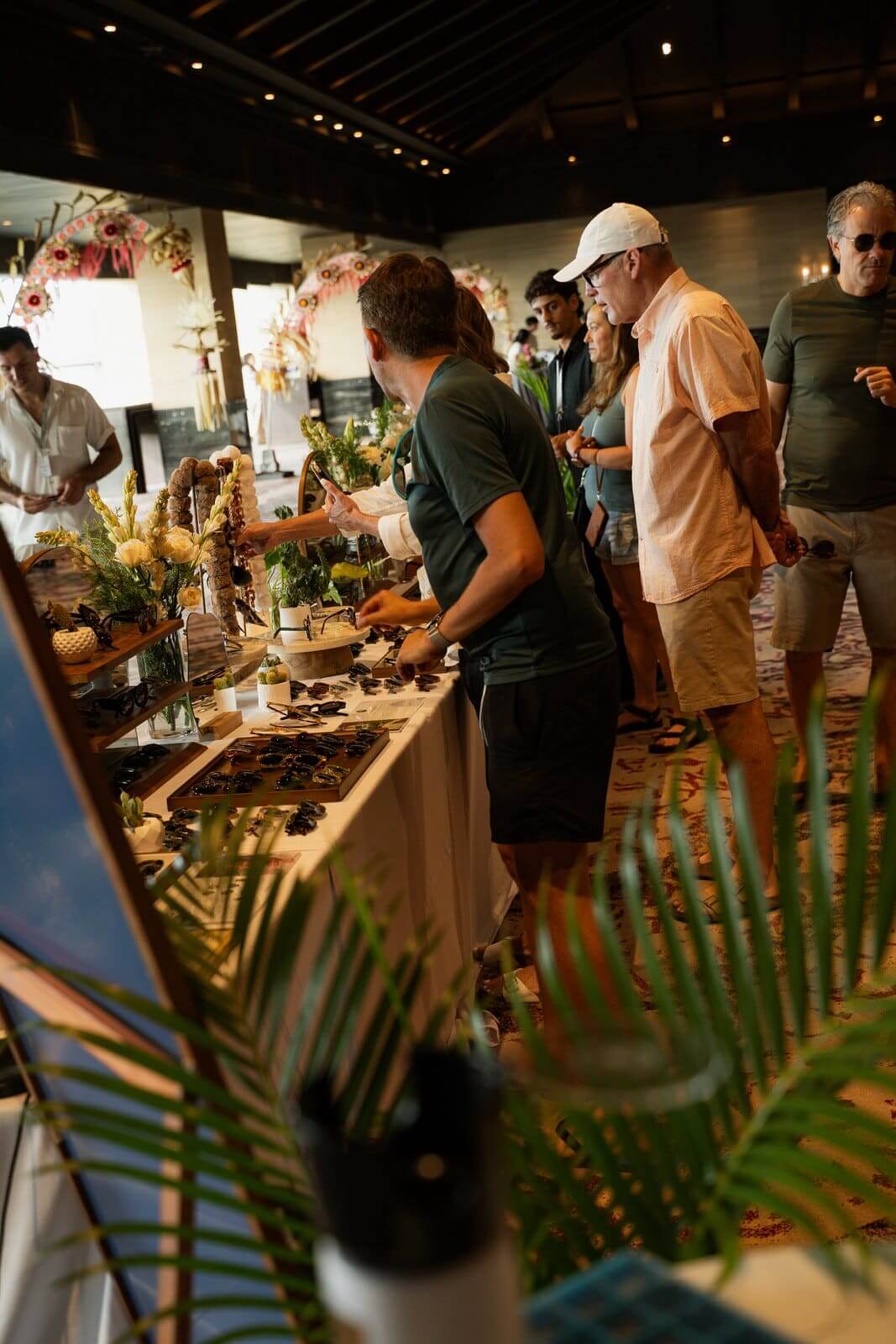 Guests gathered around a Maison Mata pop-up eyewear display at a resort event in Bali