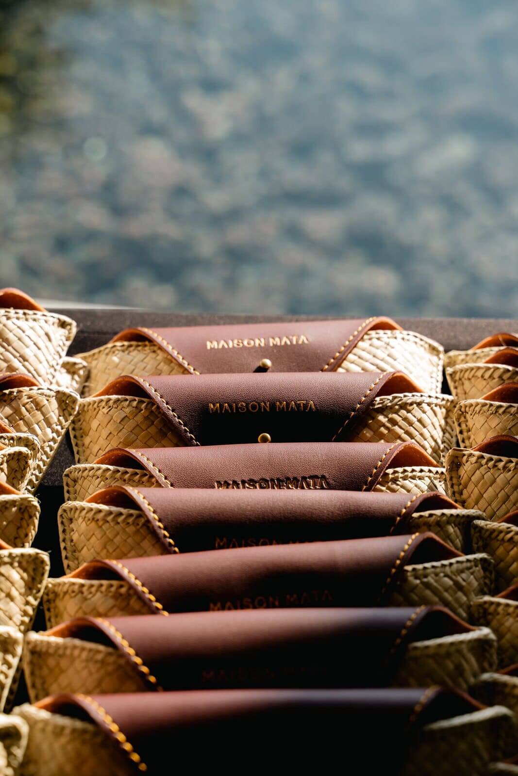 Maison Mata eyewear cases lined up in woven baskets, ready for event guests