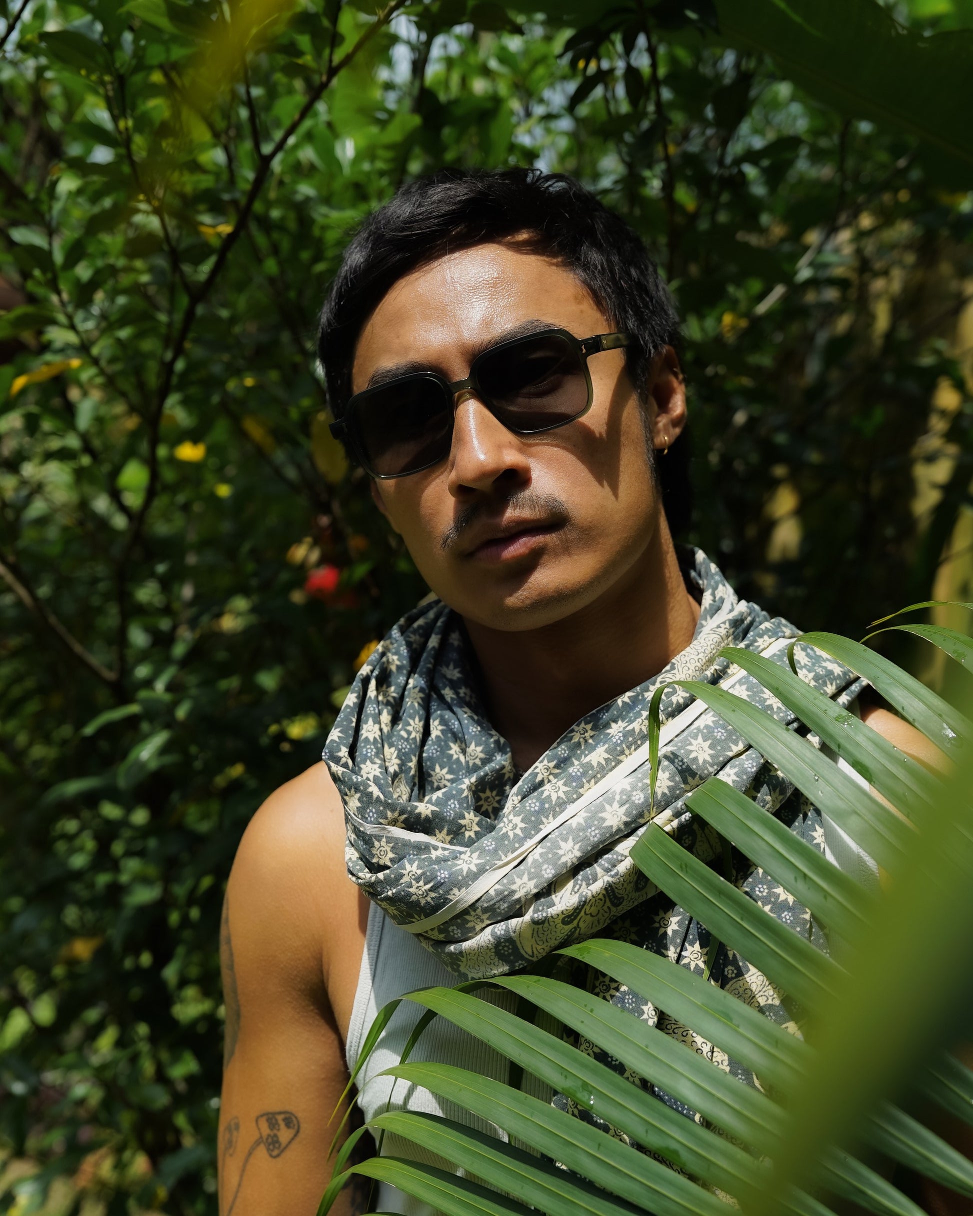 Man wearing Gili Escape Olive Gove 1970s square sunglasses
