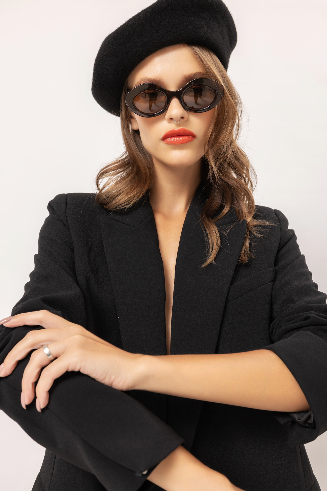 Handmade polarized sunglasses featured on a woman lounging at a villa in Bali adjusted by Maison Mata opticians.