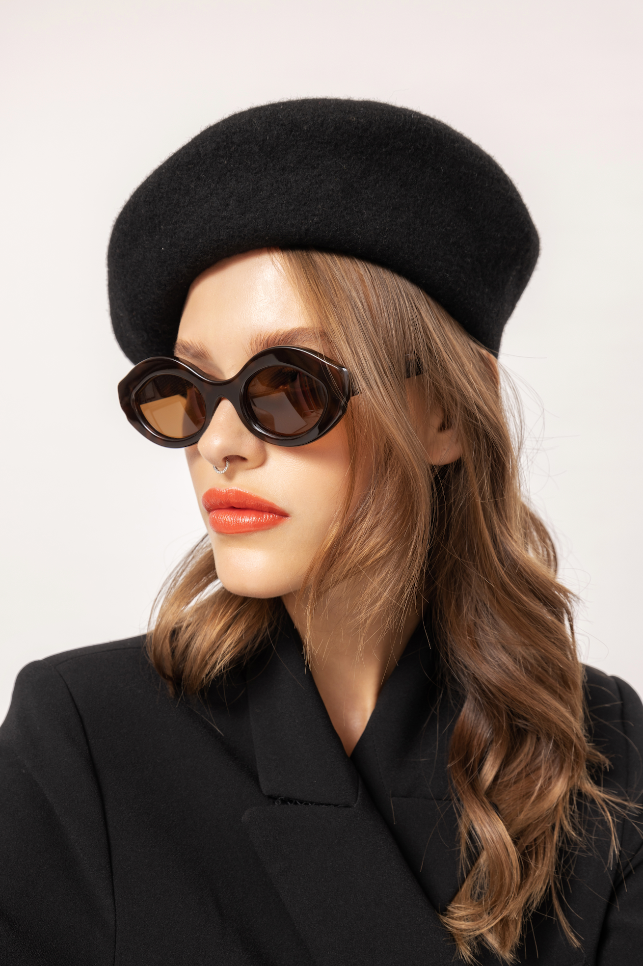 Woman modelling handmade polarized sunglasses in a Bali villa atmosphere carefully fitted by local optometrists.