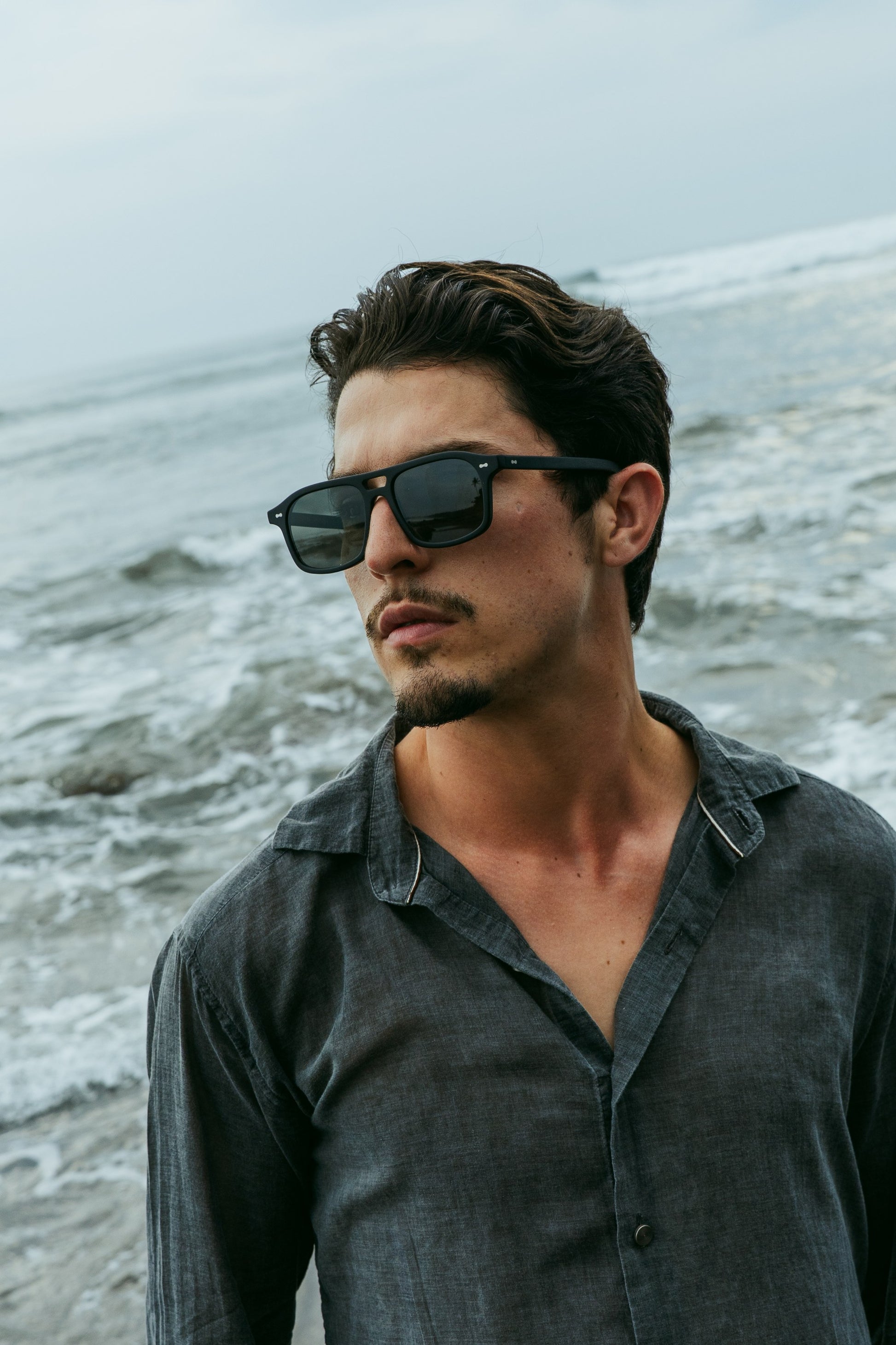 Man wearing Java Joy Velvet Noir aviator sunglasses on a Bali beach