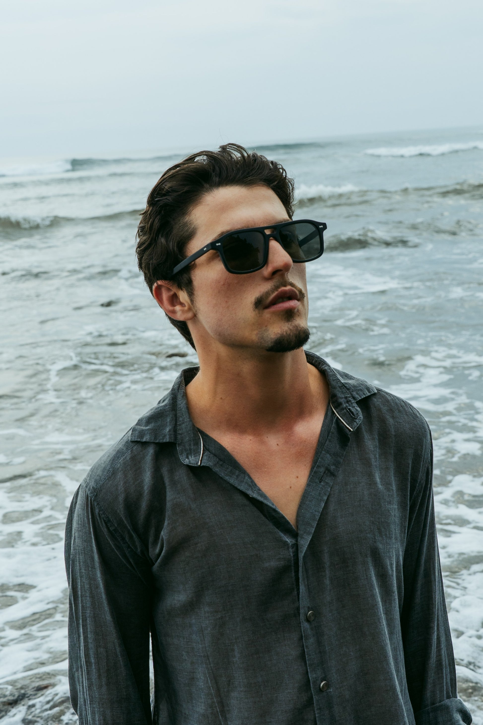 Portrait of man in Java Joy Velvet Noir black aviator sunglasses in Bali