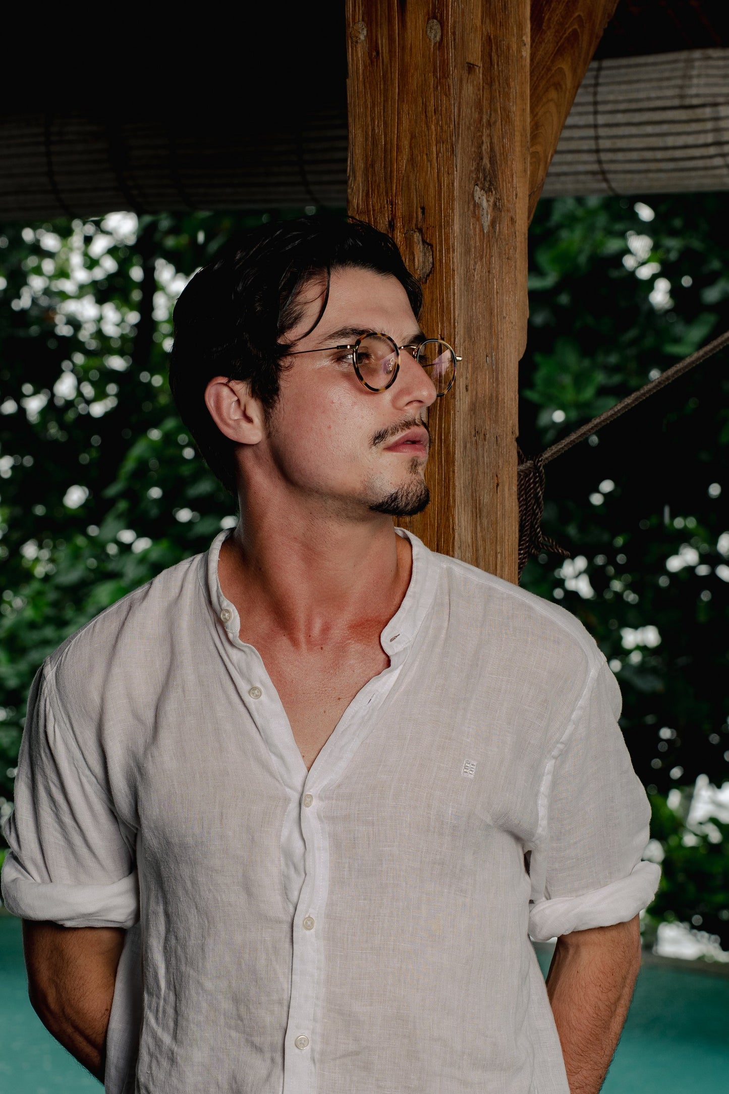 Man in Java Jungle Sunset Glow prescription glasses poolside in Bali