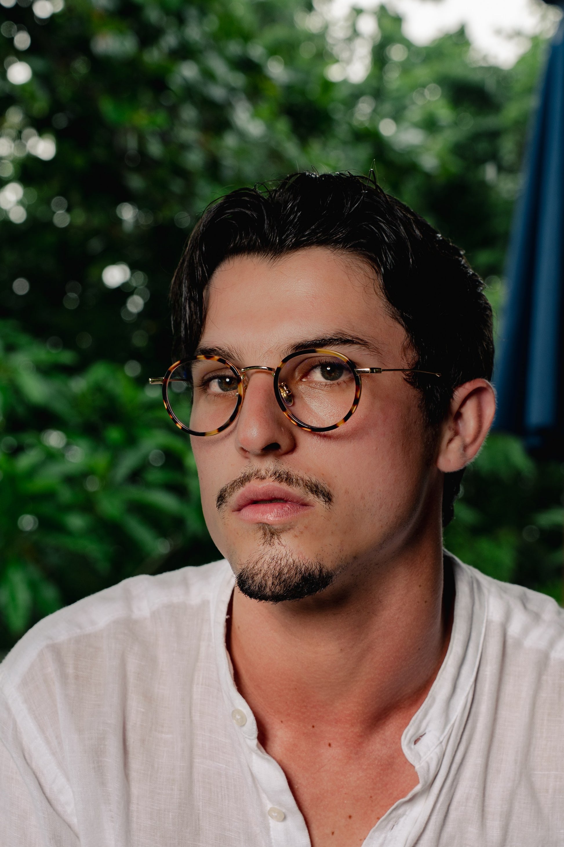 Portrait of man in Java Jungle Sunset Glow round eyeglasses