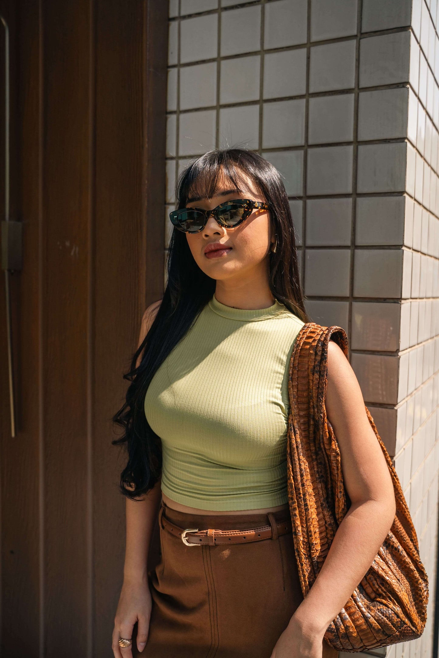Woman wearing Lombok Luxe Black Sun cat-eye acetate sunglasses in the Bali sun