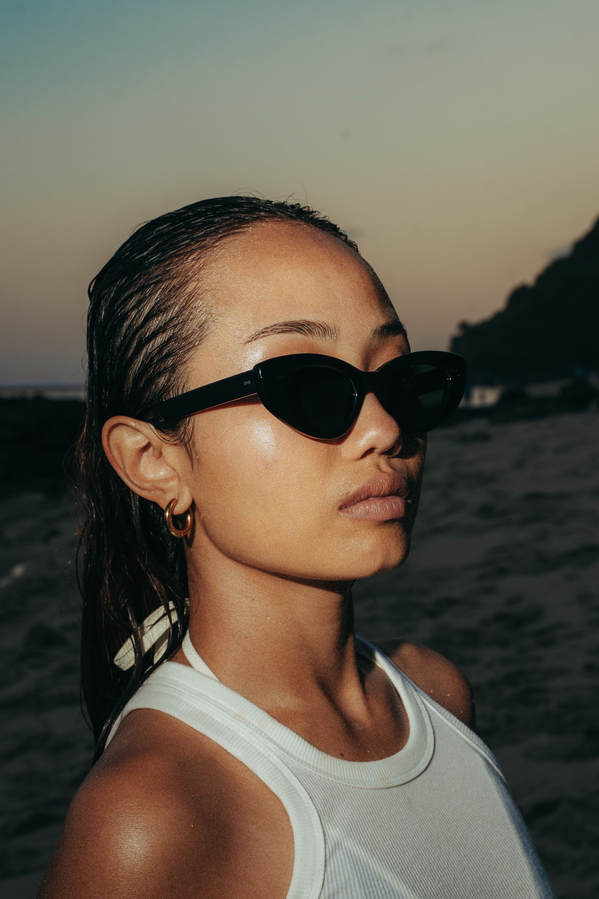Close-up of woman in Lombok Luxe Midnight Sky black cat-eye sunglasses at sunset in Bali, Maison Mata