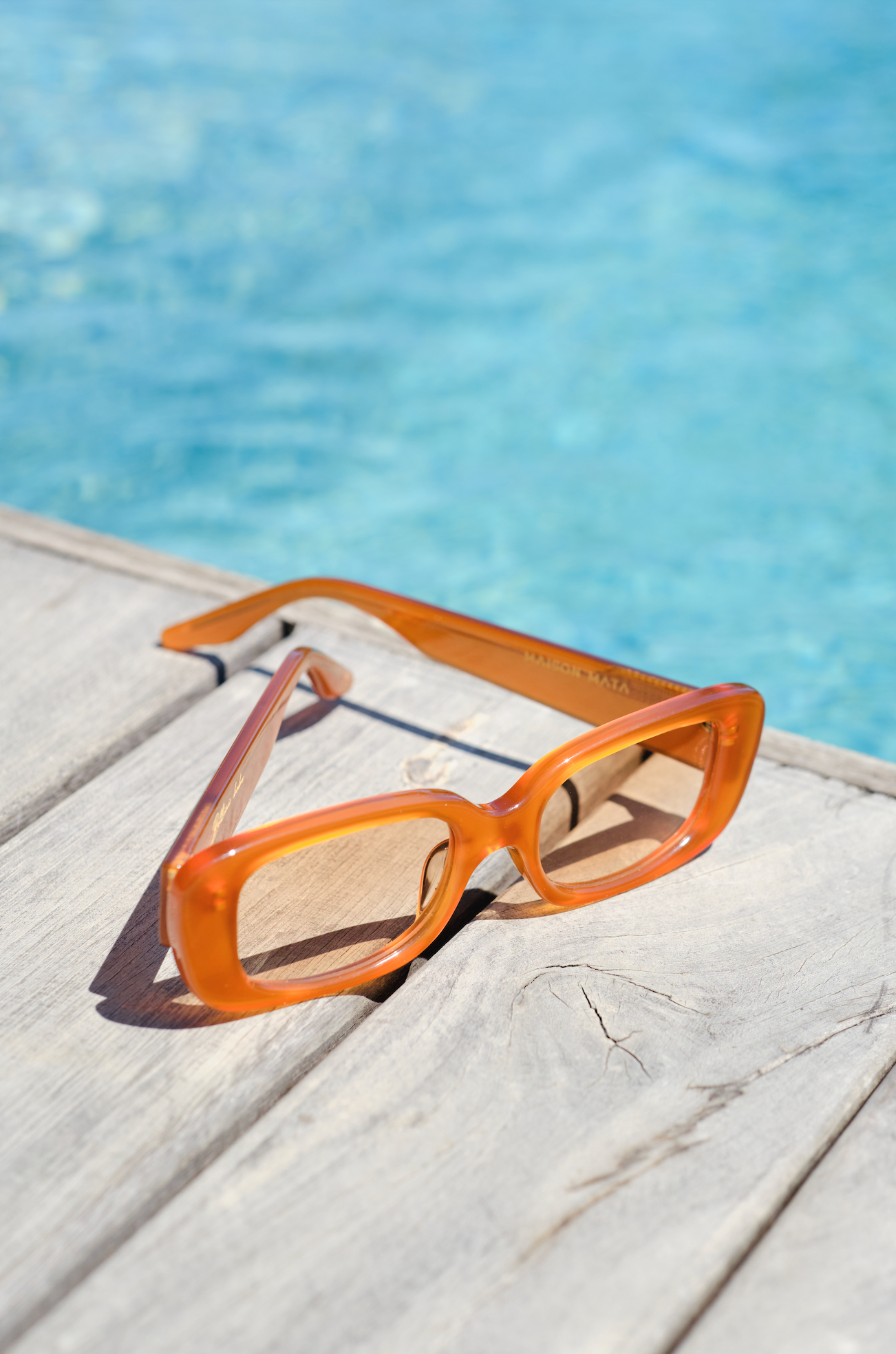 Orange rectangular polarized sunglasses for women fitted by opticians in Seminyak in Bali for modern summer style.