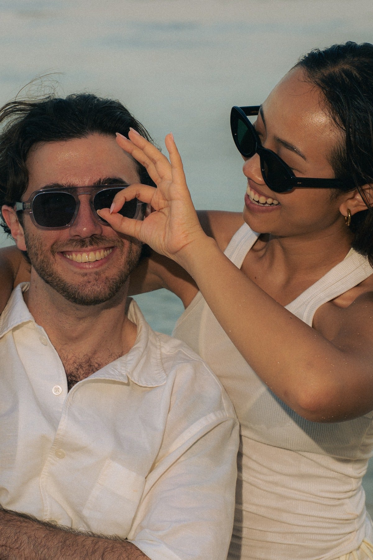 Couple wearing Maison Mata Signature Collection acetate sunglasses on a Bali beach at golden hour