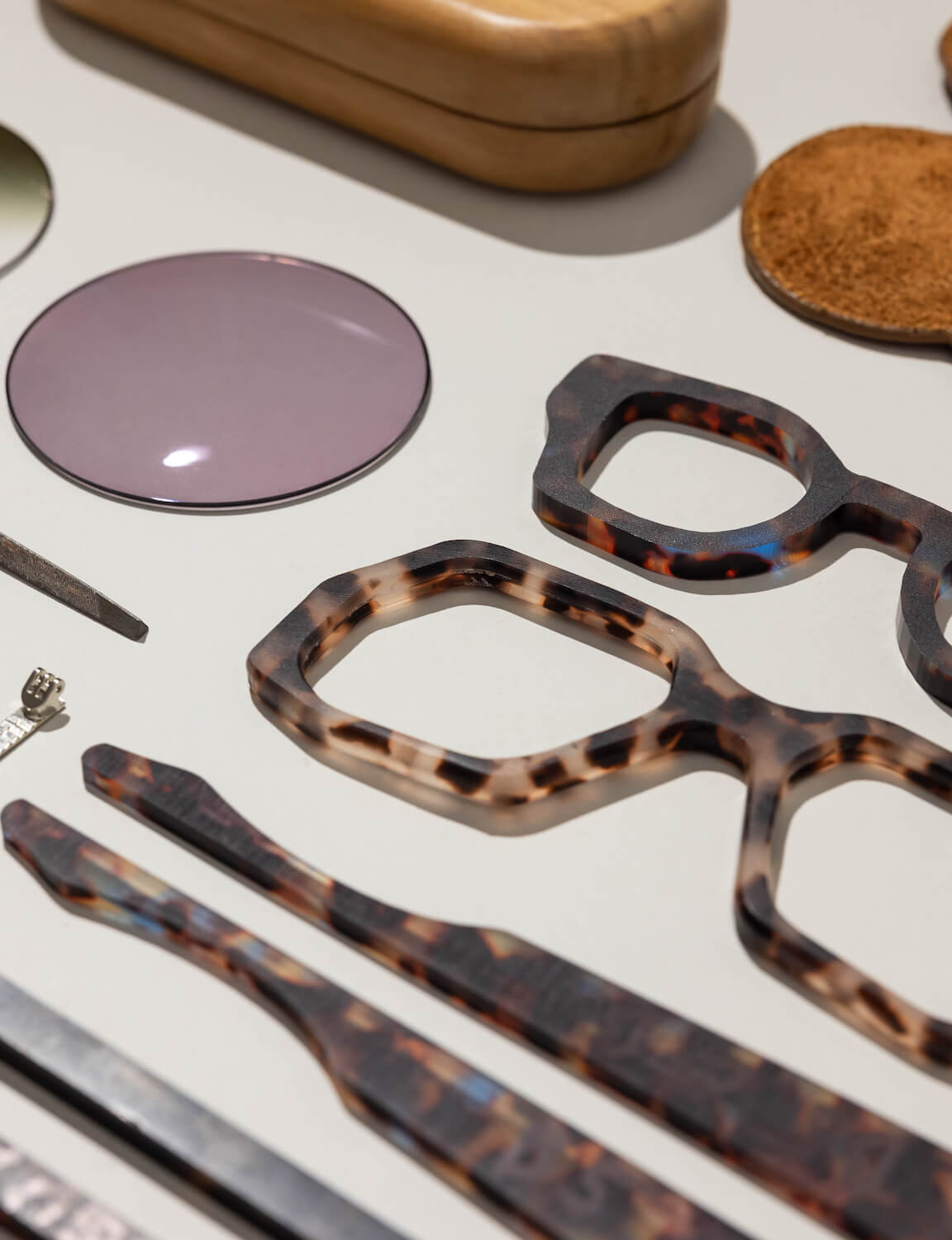 Canggu boutique eyewear section presenting optical lenses and acetate glasses in warm retail layout.