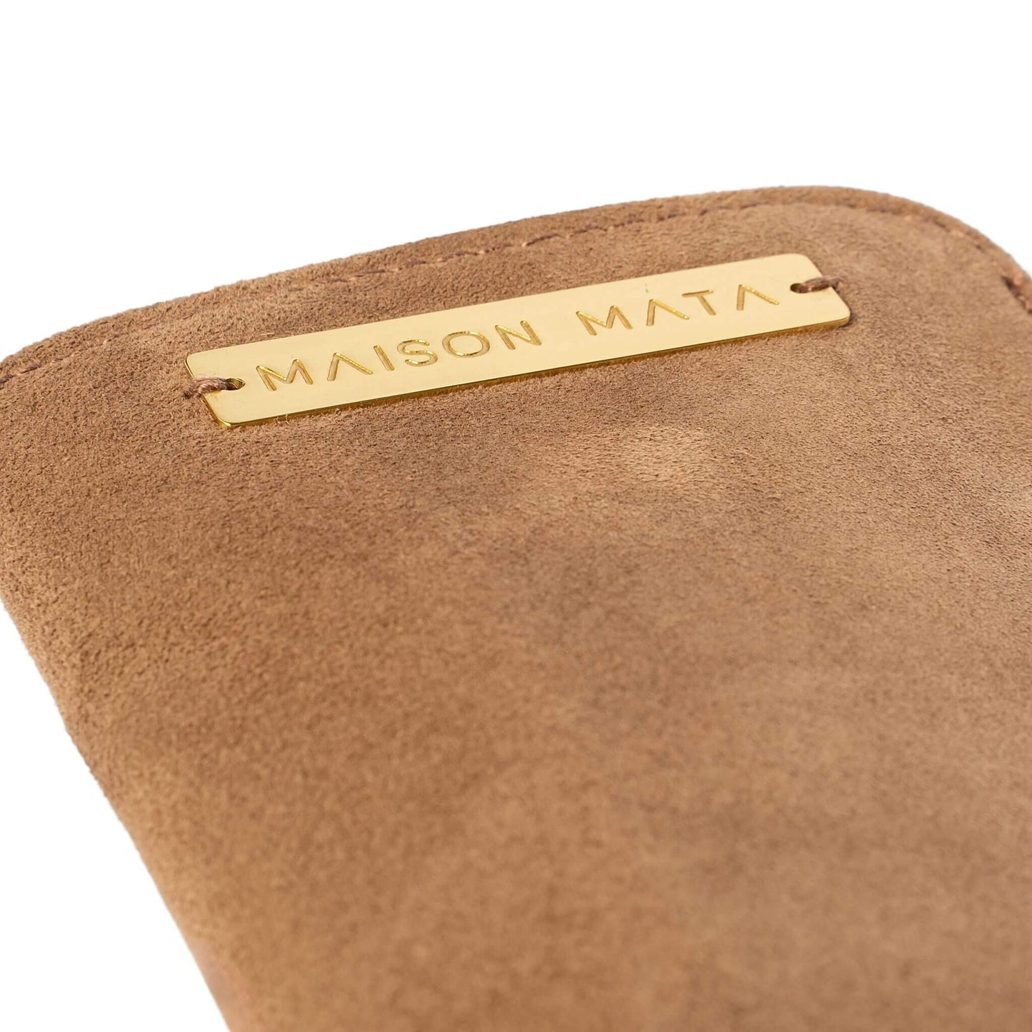 Engraved brass Maison Mata plate on the nude suede softcase
