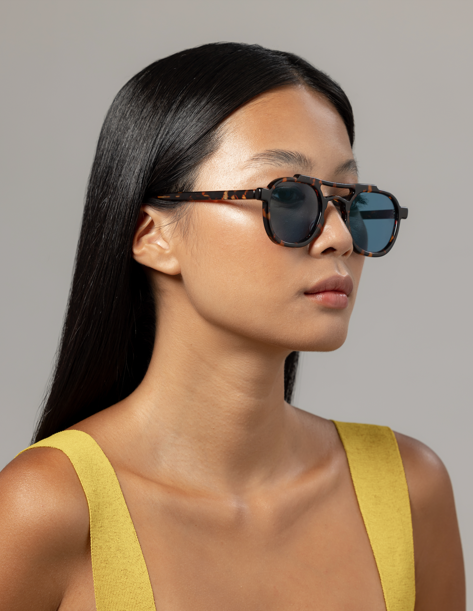 Sustainable handmade eyewear with blue-light lenses worn by a woman in Seminyak in Bali adjusted by optical specialists.