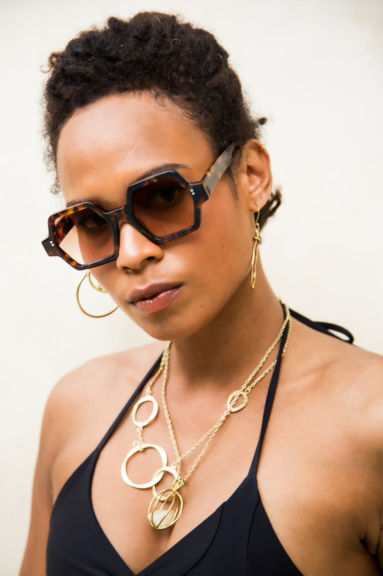 Luxury handmade polarized sunglasses portrayed on a woman near the beach in Uluwatu in Bali guided by professional optometrists.